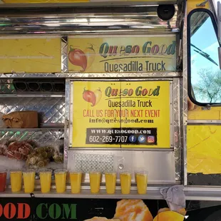 a food truck with drinks on the side