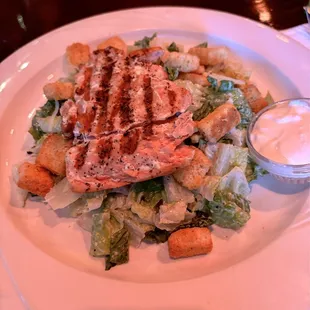 Small Caesar $6, added grilled salmon $6. Excellent.