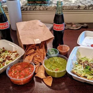 Chips with salsa/guacamole and steak and al pastor tostadas with two Mexican cokes