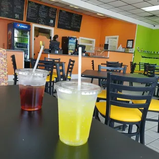 two drinks on a table in a fast food restaurant