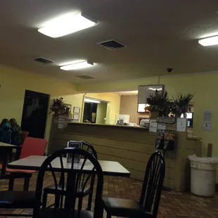a woman sitting at a table in a restaurant