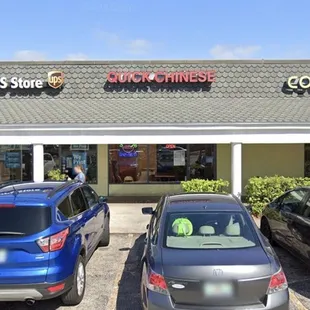 two cars parked in front of a restaurant