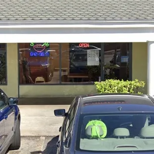 two cars parked in front of a fast food restaurant