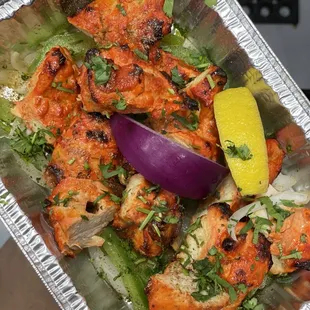 a person holding a tray of food