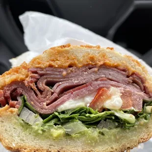 a person holding a sandwich