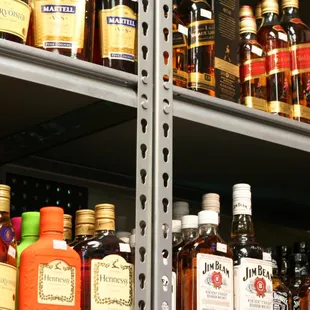a shelf full of liquor bottles