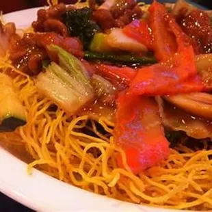 a plate of noodles with meat and vegetables