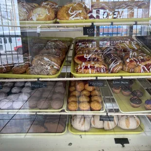 a variety of doughnuts in a display case