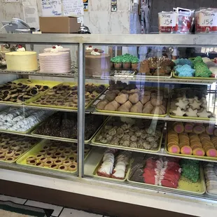 Bakery display case with a variety of cakes &amp; cookies.