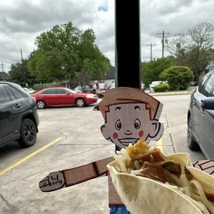 Flat Stanley indulging in a massive Hackberry Taco (egg, tortilla chips, avocado, jack cheese, poblano &amp; red onion)