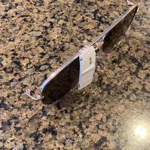 Damaged sunglasses missing an arm