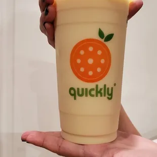 a person holding a cup of boba tea
