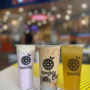 three drinks on a table at a fast food restaurant