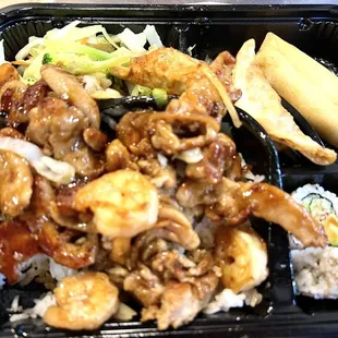 Chicken and shrimp bento box, with veggies, 2 dumplings, 2 spring rolls, 4 California rolls.