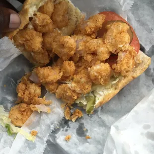 a hand holding a piece of fried chicken sandwich