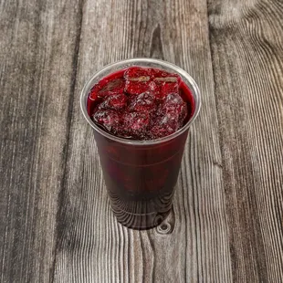 a close up of a drink on a wooden table