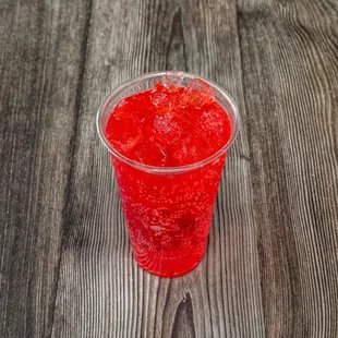 a red drink in a plastic cup