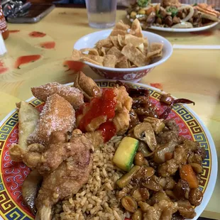 Filled plate with different foods from buffet