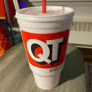 a drink in a plastic cup with a straw