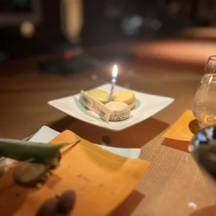 a glass of water and a plate of food on a table