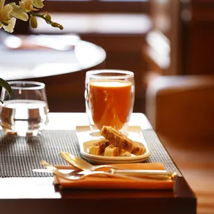 a plate of food and a glass of orange juice