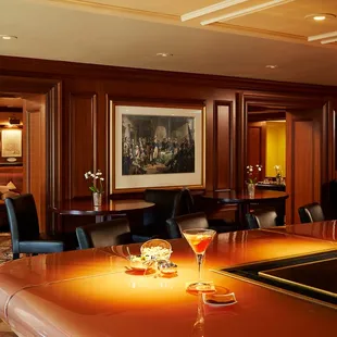 a restaurant with a bar and chairs