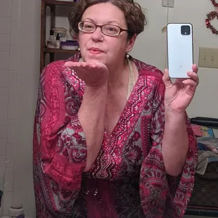 a woman taking a selfie in the mirror