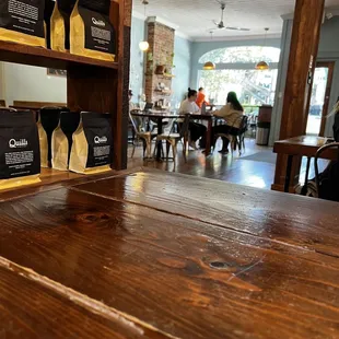 a wooden table with coffee bags on it