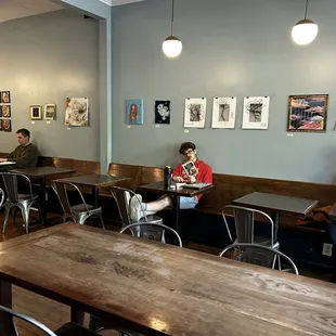 people sitting at tables in a coffee shop