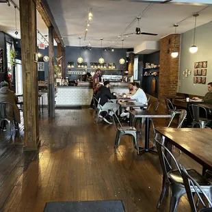people sitting at tables in a coffee shop