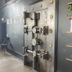a large metal door with a clock on it
