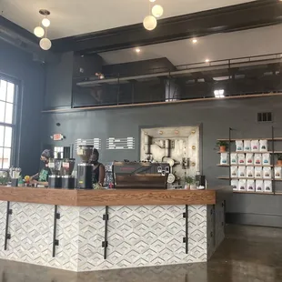 a coffee shop with a counter and stairs