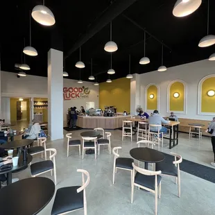 people sitting at tables in a coffee shop