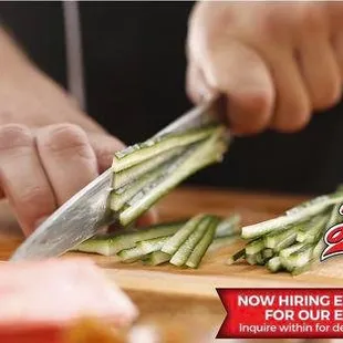 a person cutting cucumbers