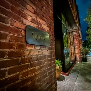 a brick building with a sign on it