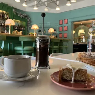 Raspberry almond cake + fresh French press coffee. Beautiful ambiance &amp; more delicious pastries awaiting.