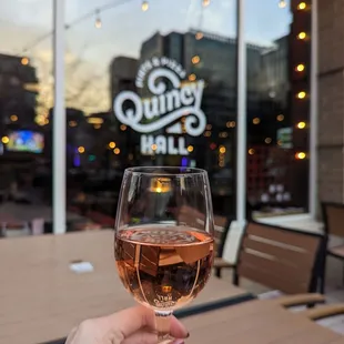 a person holding a glass of wine