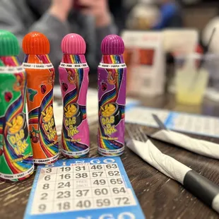 a row of bingo cards and pens