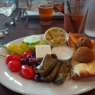 The mezza plate should've came out with the tomatoes and cucumbers cut once, the feta either crumbled or small pieces not two large blocks