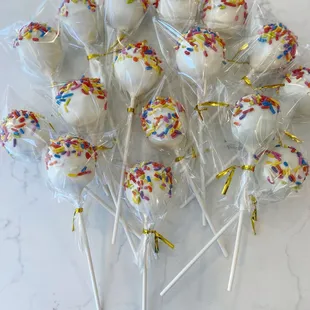 a bunch of cake pops with sprinkles