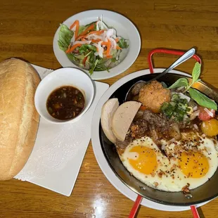 Banh Mi Chao, French bread eat with filet mignon, meat ball, pate, port patty, sunshine up eggs, and salad.