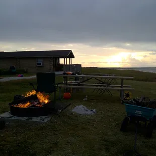 Cabin view as sun was going down with cozy campfire.