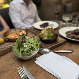 people sitting at a table with plates of food