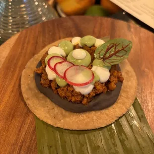 a tortilla topped with cucumbers and radishes
