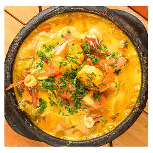 Moqueca de Peixe, delicious cod fish stew, combined with coconut milk, palm oil, lemon juice and various vegetables.