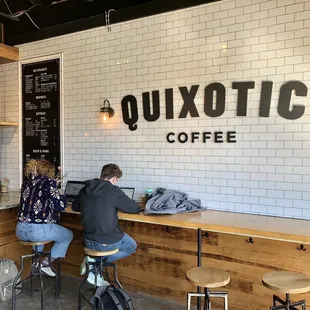two people sitting at a counter