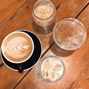 three cups of coffee on a wooden table