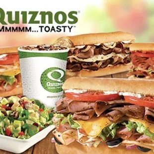 two sub sandwiches and a salad