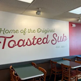 the interior of a restaurant with tables and chairs