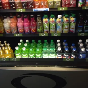 a variety of drinks on display in a grocery store